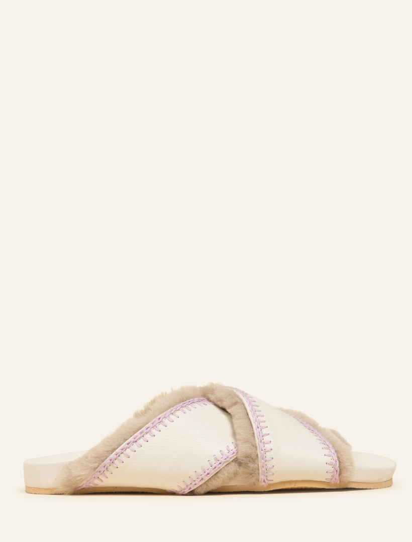 Classic slip-on sandals featuring wide suede crisscross straps and a contoured footbed with our contrast signature lilac crochet hand stitching.