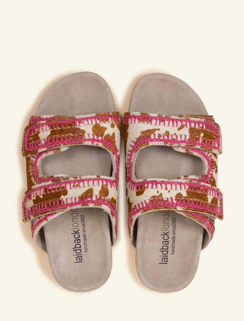 Classic slide sandals featuring double adjustable straps with contoured footbed featuring our signature pink crochet stitching.
